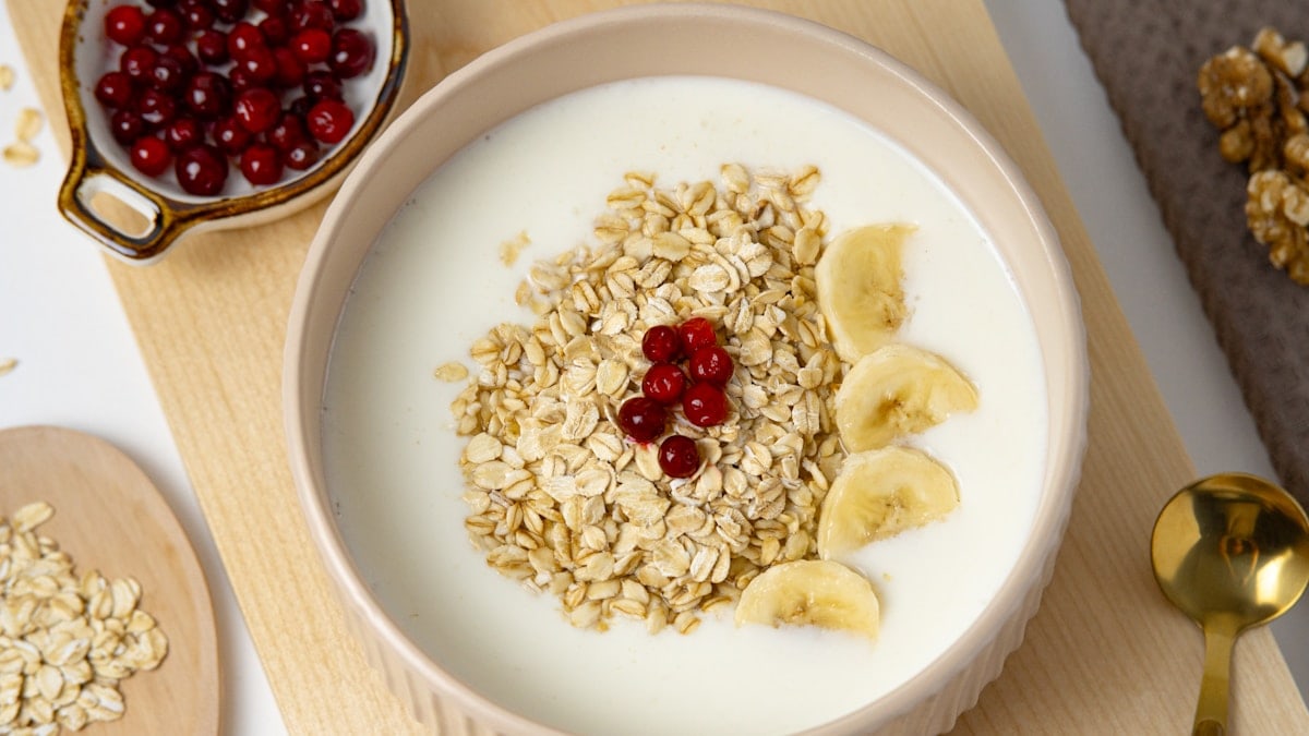 a bowl of oatmeal with bananas and cherries